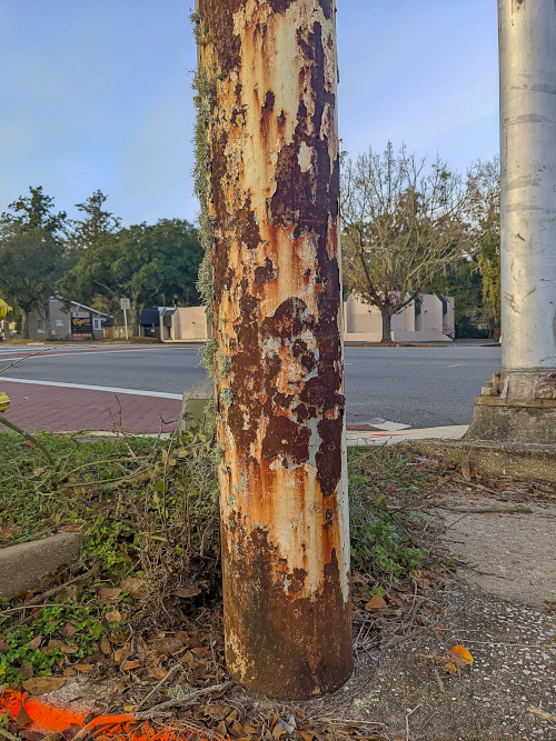 bottom of old rust sign post